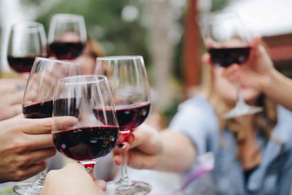 friends doing a cheers with wine glasses